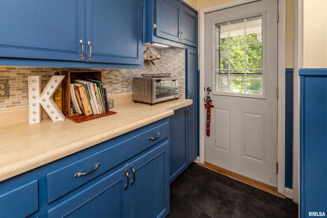 615 W Grand Ave, Carterville, IL 62918 - kitchen with blue cabinetry, light countertops, and backsplash