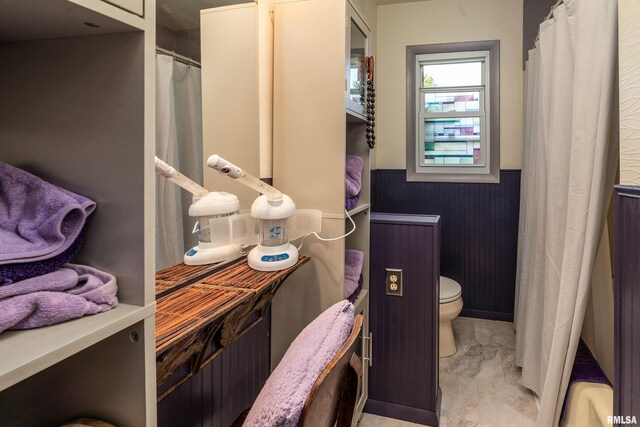 615 W Grand Ave, Carterville, IL 62918 - bathroom with wainscoting, toilet, a shower with shower curtain, and marble look tile flooring