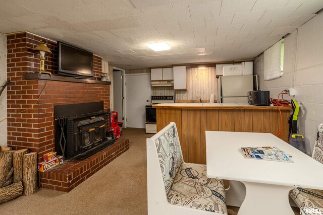 615 W Grand Ave, Carterville, IL 62918 - kitchen with electric range, freestanding refrigerator, a peninsula, under cabinet range hood, and carpet