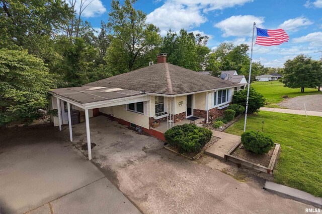 615 W Grand Ave, Carterville, IL 62918 - single story home with a front yard, concrete driveway, a chimney, roof with shingles, and an attached carport