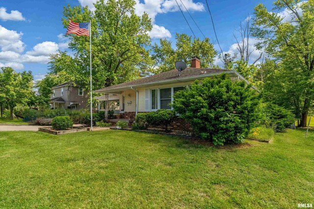 615 W Grand Ave, Carterville, IL 62918 - view of front facade featuring a front lawn, a chimney, and brick siding