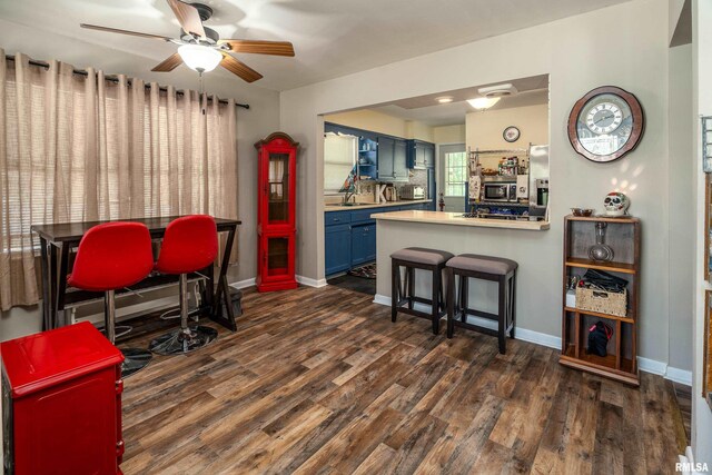 615 W Grand Ave, Carterville, IL 62918 - dining space featuring ceiling fan, dark wood-style floors, and baseboards