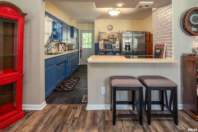 615 W Grand Ave, Carterville, IL 62918 - kitchen featuring blue cabinetry, appliances with stainless steel finishes, a sink, open shelves, and light countertops