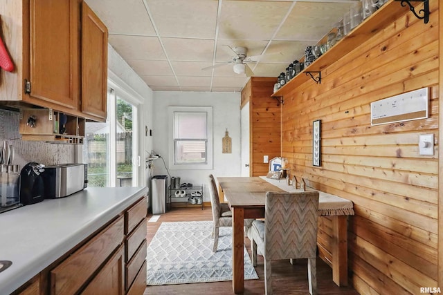3414 Fillmore Ln, Davenport, IA 52806 - dining space with wood finished floors, a ceiling fan, and wood walls