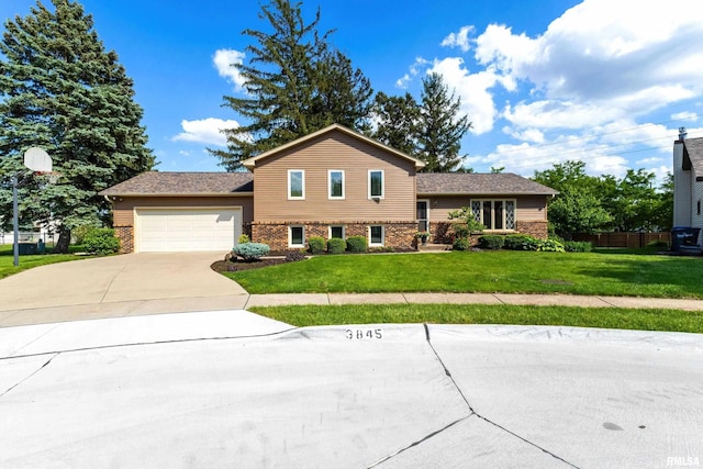 3845 Norwich Ct, Bettendorf, IA 52722 - tri-level home featuring brick siding, an attached garage, and concrete driveway