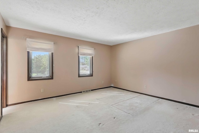 3845 Norwich Ct, Bettendorf, IA 52722 - empty room featuring a textured ceiling, carpet floors, and baseboards