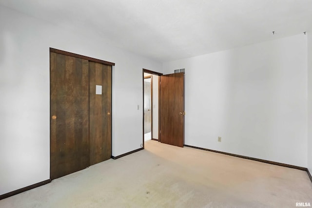 3845 Norwich Ct, Bettendorf, IA 52722 - unfurnished bedroom featuring baseboards, light carpet, and a closet