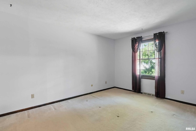 3845 Norwich Ct, Bettendorf, IA 52722 - carpeted empty room with baseboards and a textured ceiling