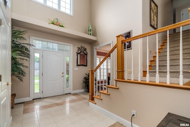 1404 Belle Terre Ct, Herrin, IL 62948 - tiled foyer with a high ceiling, baseboards, stairs, and inlaid floor details