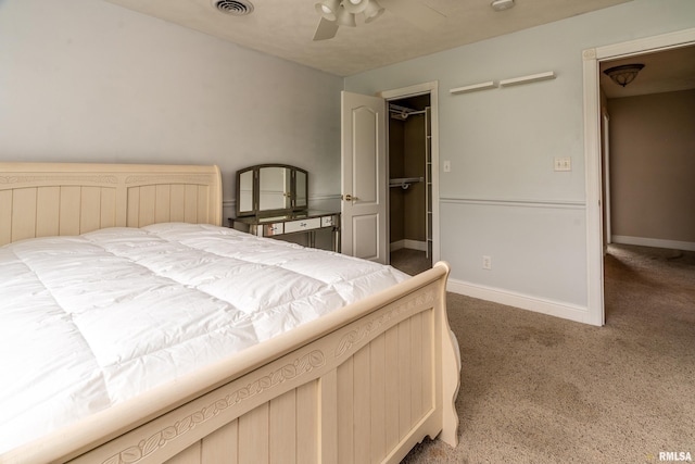 1404 Belle Terre Ct, Herrin, IL 62948 - carpeted bedroom with a walk in closet, baseboards, and a ceiling fan