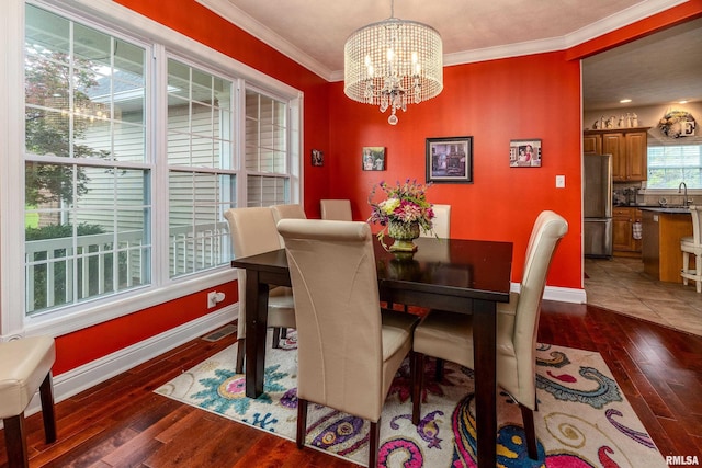 1404 Belle Terre Ct, Herrin, IL 62948 - dining space featuring a chandelier, ornamental molding, baseboards, and hardwood / wood-style floors