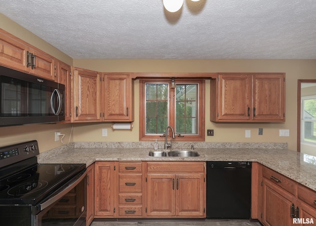 4760 Apple Valley Dr, Bettendorf, IA 52722 - kitchen with electric range oven, black dishwasher, a sink, a textured ceiling, and brown cabinetry