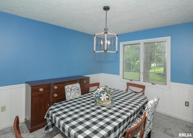 4760 Apple Valley Dr, Bettendorf, IA 52722 - carpeted dining area with a wainscoted wall, a textured ceiling, and a chandelier