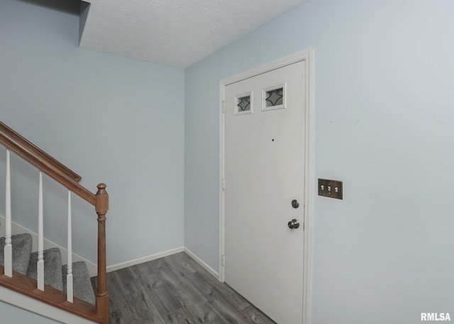 4760 Apple Valley Dr, Bettendorf, IA 52722 - foyer with wood finished floors, stairs, a textured ceiling, and baseboards
