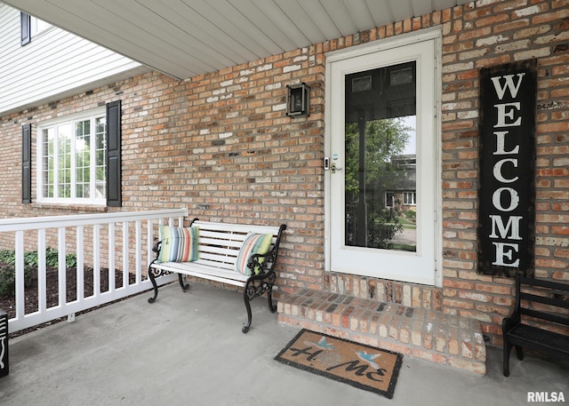 4760 Apple Valley Dr, Bettendorf, IA 52722 - property entrance with a porch and brick siding