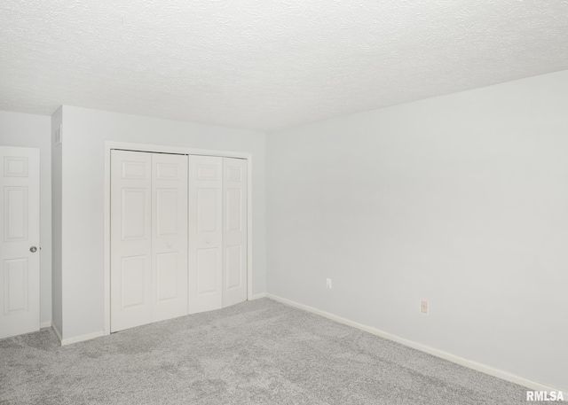 4760 Apple Valley Dr, Bettendorf, IA 52722 - unfurnished bedroom with carpet, a closet, and a textured ceiling