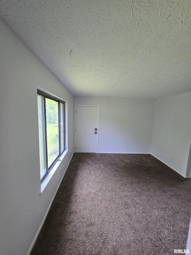 3920 13th St, Davenport, IA 52804 - spare room featuring carpet flooring, a textured ceiling, and baseboards