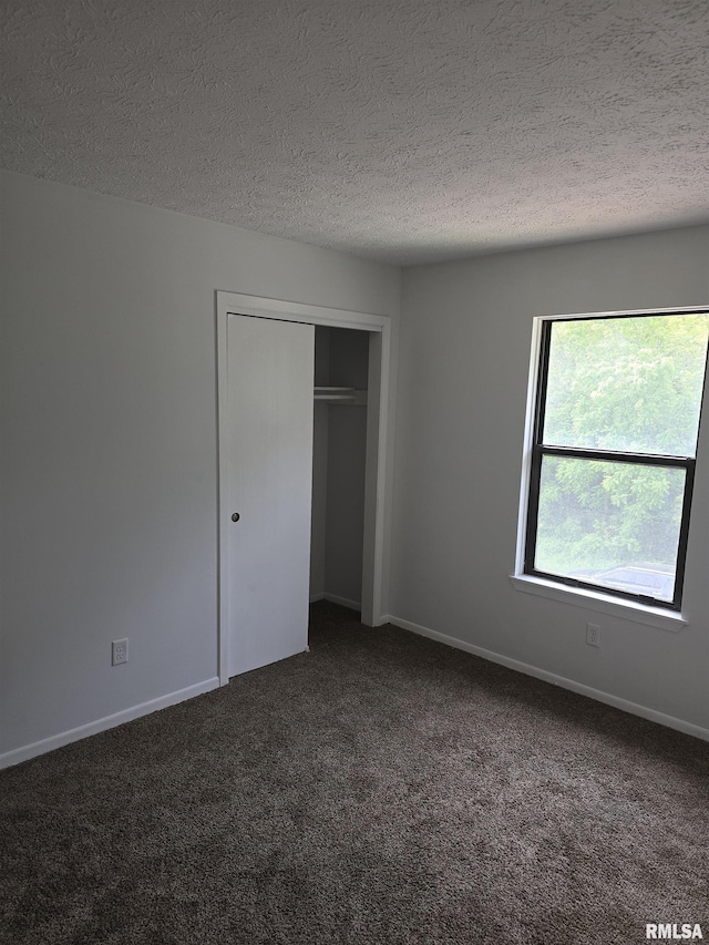 3920 13th St, Davenport, IA 52804 - unfurnished bedroom with carpet floors, a textured ceiling, a closet, and baseboards