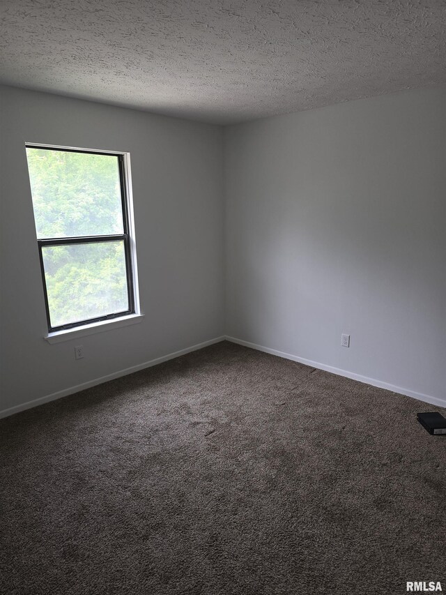 3920 13th St, Davenport, IA 52804 - empty room with dark carpet, a textured ceiling, and baseboards