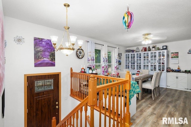 911 Cardinal Dr, Maquoketa, IA 52060 - dining space with a chandelier, wood finished floors, and a ceiling fan