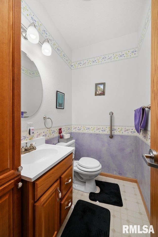 911 Cardinal Dr, Maquoketa, IA 52060 - half bath featuring vanity, toilet, and tile patterned floors