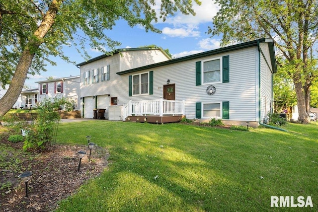 911 Cardinal Dr, Maquoketa, IA 52060 - rear view of property with an attached garage, a yard, and a deck