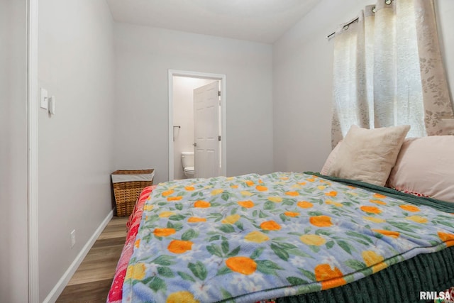 404 S 23rd St, Herrin, IL 62948 - bedroom with wood finished floors, baseboards, and ensuite bathroom