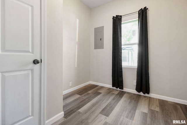 404 S 23rd St, Herrin, IL 62948 - empty room with electric panel, wood finished floors, and baseboards