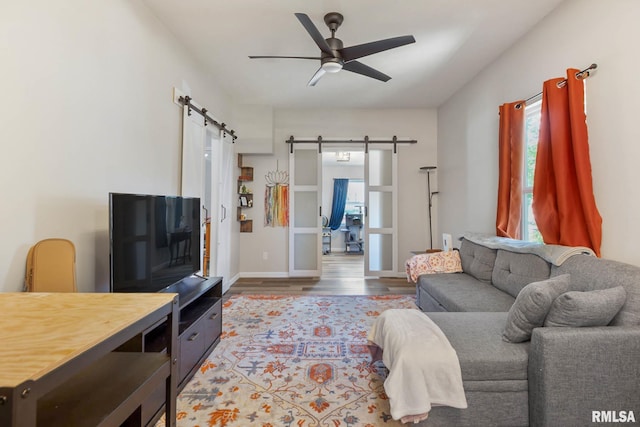 404 S 23rd St, Herrin, IL 62948 - living area featuring a barn door, a ceiling fan, wood finished floors, and baseboards