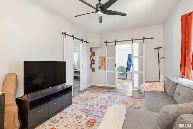 404 S 23rd St, Herrin, IL 62948 - living room with a barn door, ceiling fan, wood finished floors, and baseboards