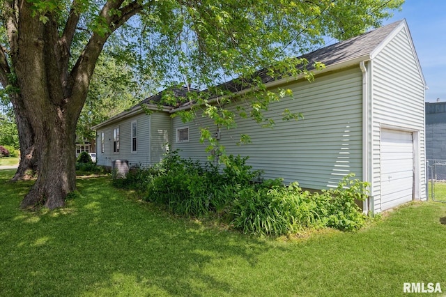 417 12th St, De Witt, IA 52742 - view of side of property with a lawn and a garage