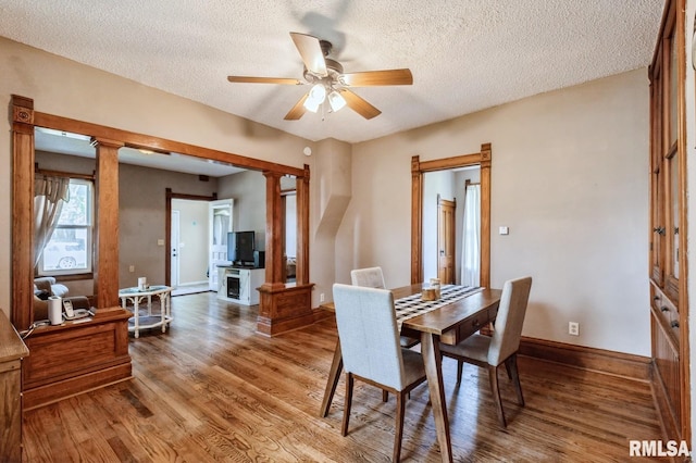 417 12th St, De Witt, IA 52742 - dining space with wood finished floors, baseboards, a ceiling fan, and a textured ceiling