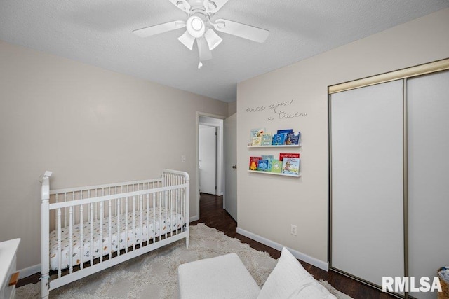 5647 Quercus Ln, Davenport, IA 52806 - bedroom with a closet, a crib, ceiling fan, and baseboards