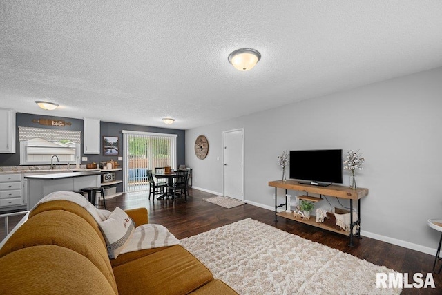 5647 Quercus Ln, Davenport, IA 52806 - living room with dark wood-style flooring, baseboards, and a textured ceiling