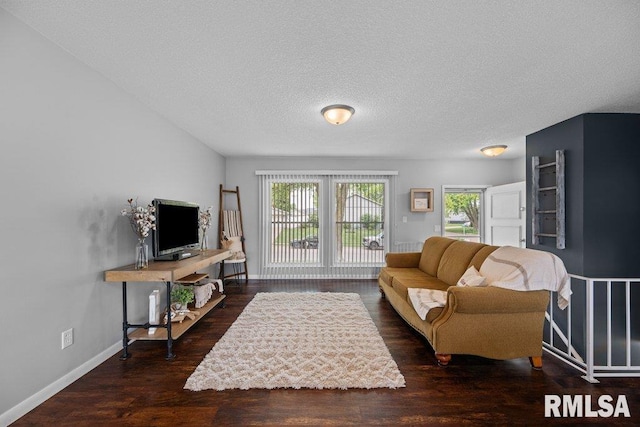 5647 Quercus Ln, Davenport, IA 52806 - living area featuring wood finished floors, baseboards, and a textured ceiling