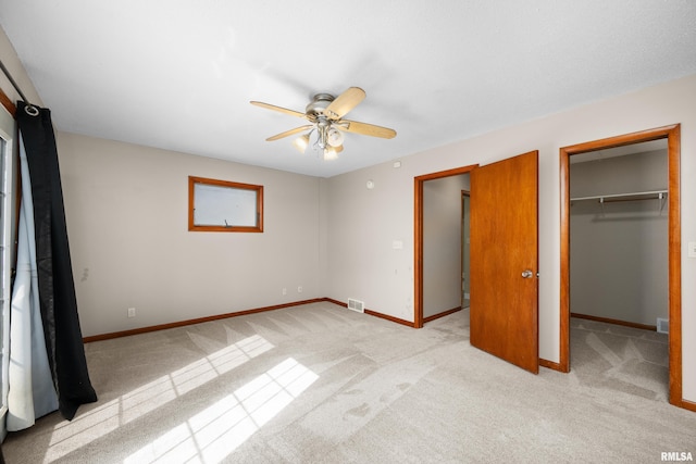 2920 Roosevelt St, Clinton, IA 52732 - unfurnished bedroom with light colored carpet, a spacious closet, and baseboards