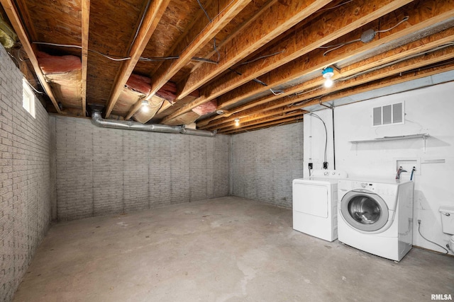 2920 Roosevelt St, Clinton, IA 52732 - unfinished basement featuring washer and dryer and brick wall