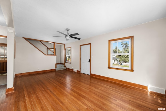 2920 Roosevelt St, Clinton, IA 52732 - unfurnished living room with wood finished floors, baseboards, and ceiling fan