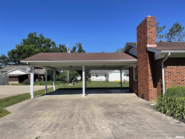 201 S Herrmann Dr, Ridgway, IL 62979 - view of parking with concrete driveway and a carport