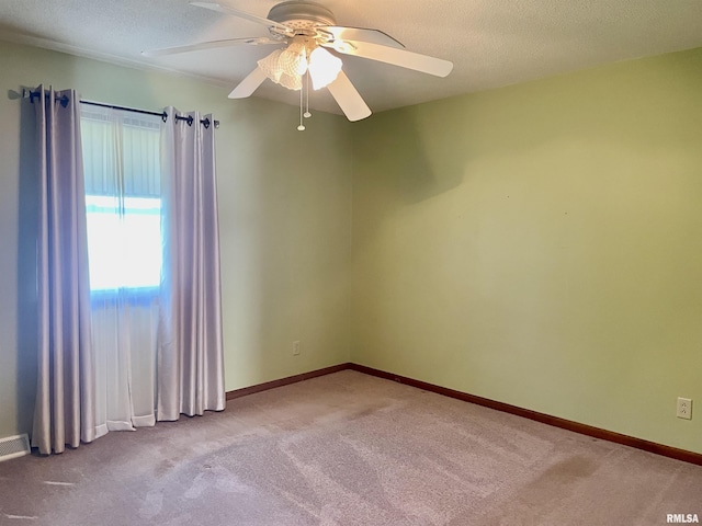 201 S Herrmann Dr, Ridgway, IL 62979 - empty room featuring a ceiling fan, carpet floors, baseboards, and a textured ceiling