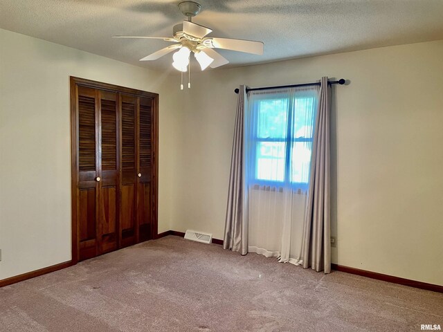 201 S Herrmann Dr, Ridgway, IL 62979 - unfurnished bedroom featuring carpet flooring, a textured ceiling, ceiling fan, a closet, and baseboards