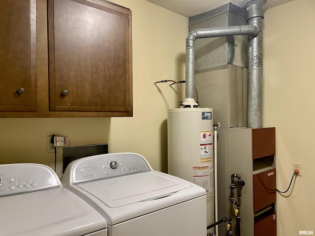201 S Herrmann Dr, Ridgway, IL 62979 - washroom with washing machine and dryer, cabinet space, and gas water heater