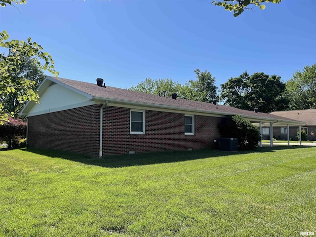 201 S Herrmann Dr, Ridgway, IL 62979 - view of side of home featuring brick siding, a lawn, central air condition unit, and a shingled roof
