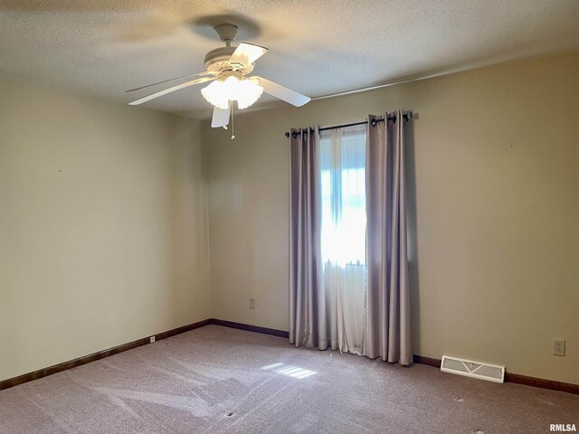 201 S Herrmann Dr, Ridgway, IL 62979 - spare room with carpet floors, a ceiling fan, baseboards, and a textured ceiling
