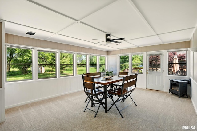 5760 Jenny Ln, Bettendorf, IA 52722 - sunroom with a wood stove, plenty of natural light, and carpet flooring