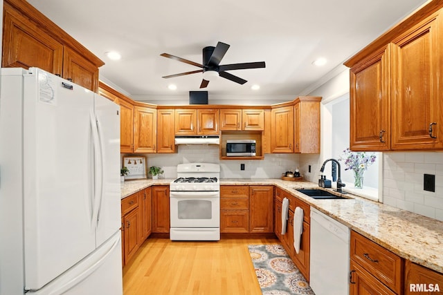 5760 Jenny Ln, Bettendorf, IA 52722 - kitchen featuring white appliances, a sink, brown cabinetry, crown molding, and light wood-type flooring
