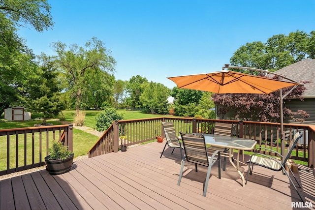 5760 Jenny Ln, Bettendorf, IA 52722 - deck with outdoor dining area, a yard, and view of wooded area
