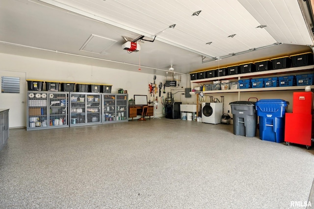 5760 Jenny Ln, Bettendorf, IA 52722 - garage featuring washer / dryer, a garage door opener, and a sink