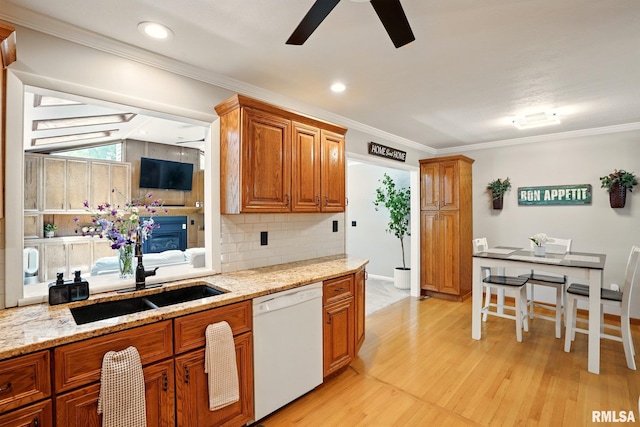 5760 Jenny Ln, Bettendorf, IA 52722 - kitchen featuring white dishwasher, a ceiling fan, a sink, brown cabinetry, and ornamental molding