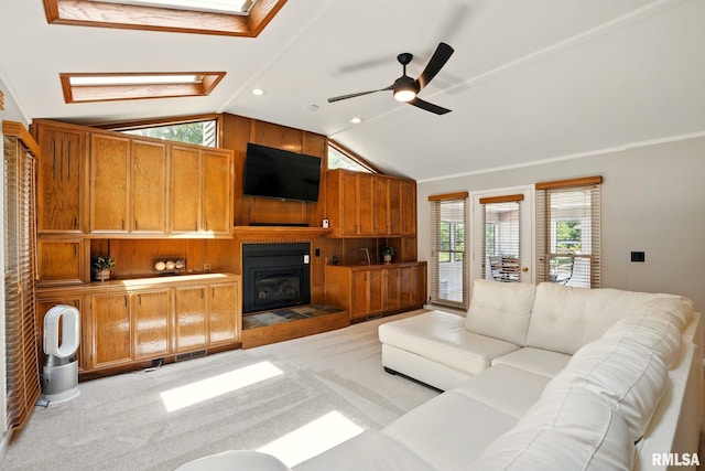 5760 Jenny Ln, Bettendorf, IA 52722 - living area with a skylight, vaulted ceiling, ceiling fan, light colored carpet, and a fireplace
